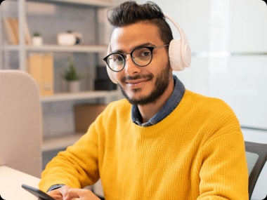 photo of real estate virtual assistant sitting at a desk with headphones on