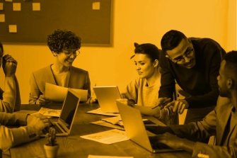 A group of people discussing in an office setting