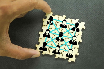Puzzles with icons of a group of team workers