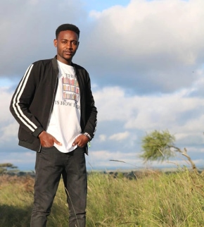 Joshua, Pathways Student, in a field in Kenya