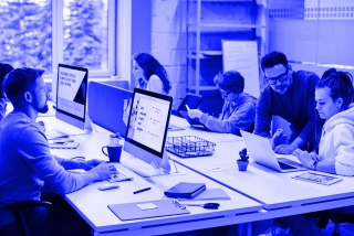 People working on computers in a modern office environment