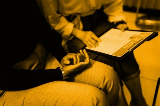 Two people discussing HR documents in an office