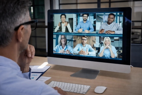 Global remote team collaborating through video call with an international remote hiring agency