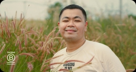 Smiling person standing in a field