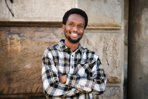 Man smiling with his arms crossed